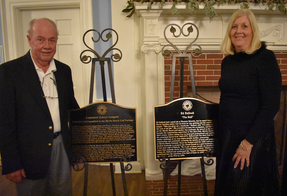 Larry Leagans and Trisha Bullock, daughter of Ed Bullock, with honoree plaques to commemorate their enshrinement in the Myrtle Beach Golf Hall of Fame